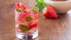 Strawberry mojito served with lime and crushed ice